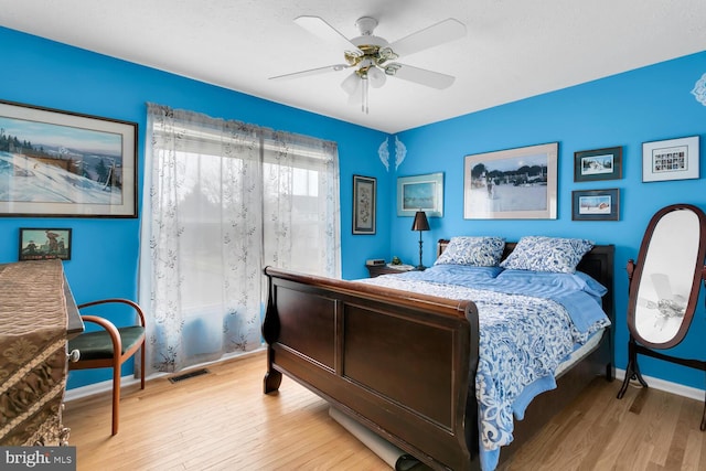 bedroom with ceiling fan and light wood-type flooring