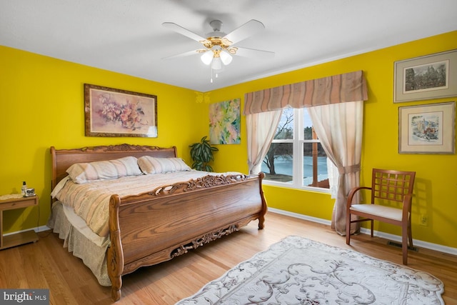 bedroom featuring hardwood / wood-style flooring and ceiling fan