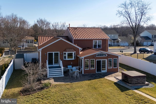 rear view of house featuring a yard