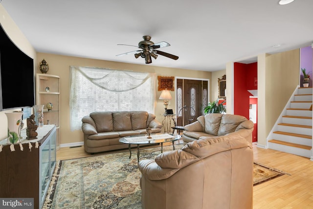 living room with wood-type flooring and ceiling fan