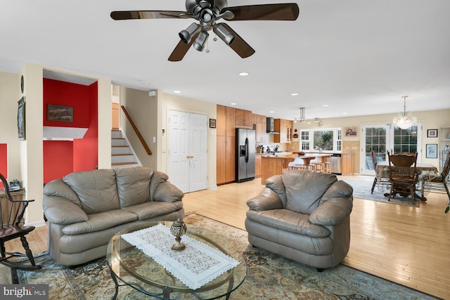 living room featuring ceiling fan and light wood-type flooring