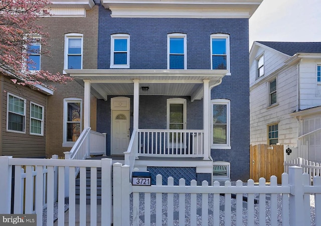 townhome / multi-family property with covered porch