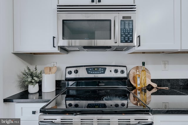 kitchen featuring stainless steel appliances and white cabinets