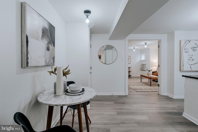 hallway with light hardwood / wood-style floors