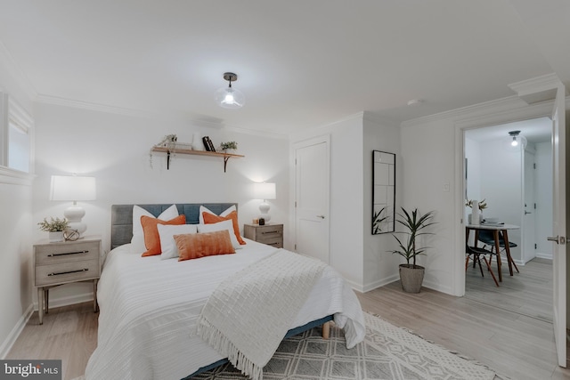 bedroom featuring ornamental molding and light wood-type flooring