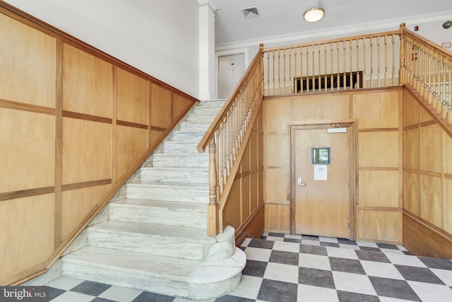 stairway featuring crown molding