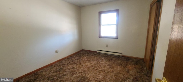 unfurnished room with dark colored carpet and baseboard heating