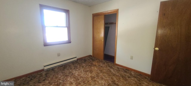 unfurnished bedroom featuring a baseboard radiator, a closet, and carpet