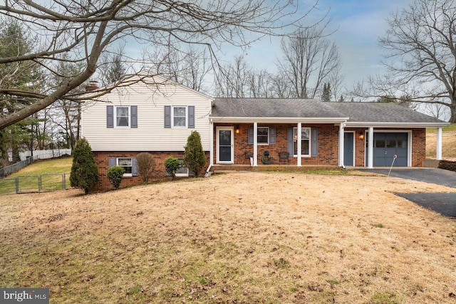 split level home featuring a garage and a front yard