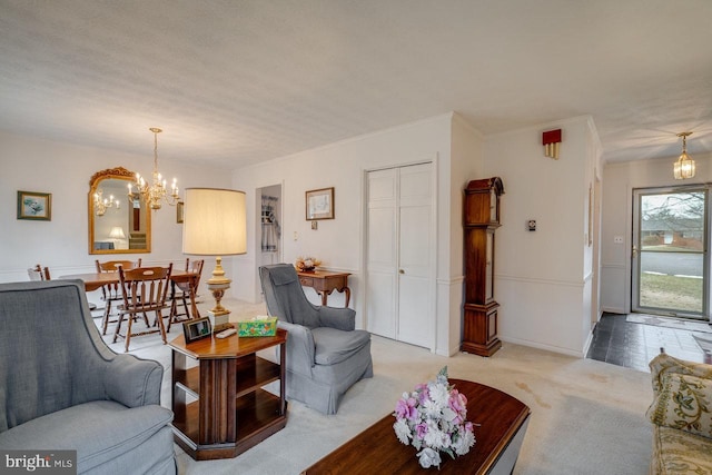 carpeted living room with a chandelier