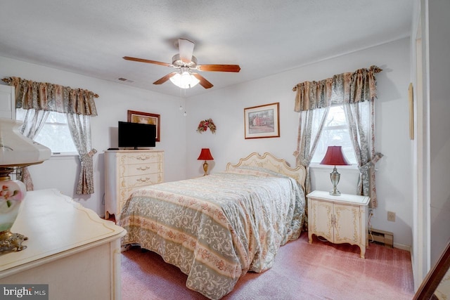 bedroom with ceiling fan, carpet flooring, and baseboard heating