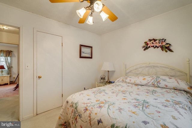 bedroom featuring ceiling fan and light carpet