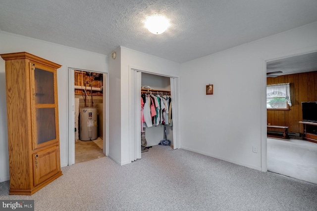 carpeted bedroom featuring electric water heater, a closet, and a textured ceiling