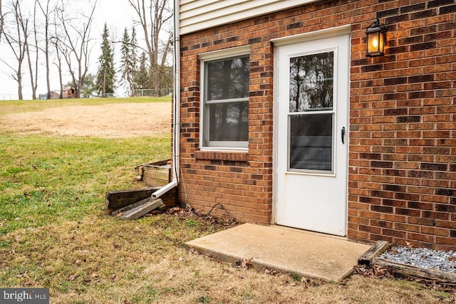 entrance to property with a lawn