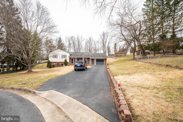 view of front of property featuring a garage and a front yard