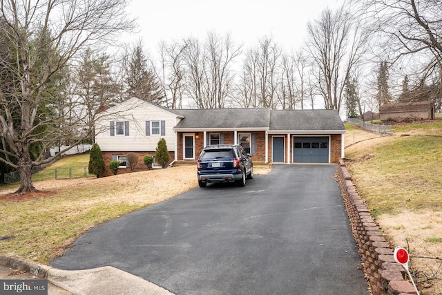 split level home featuring a garage and a front lawn