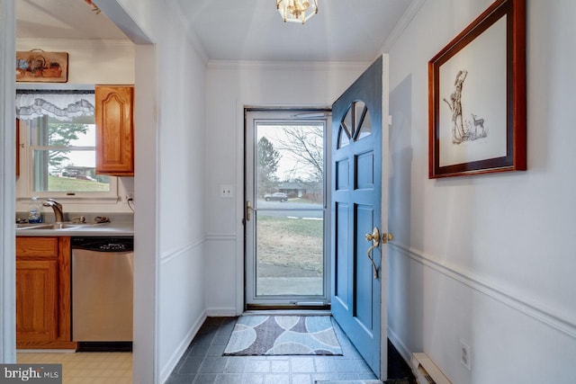 doorway with sink, a wealth of natural light, and ornamental molding