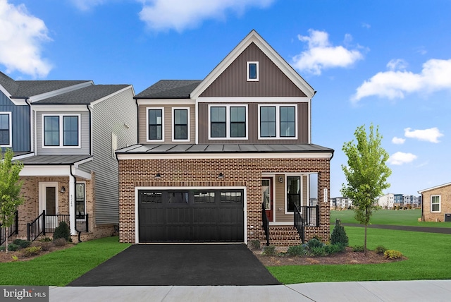 view of front of home featuring a garage and a front lawn