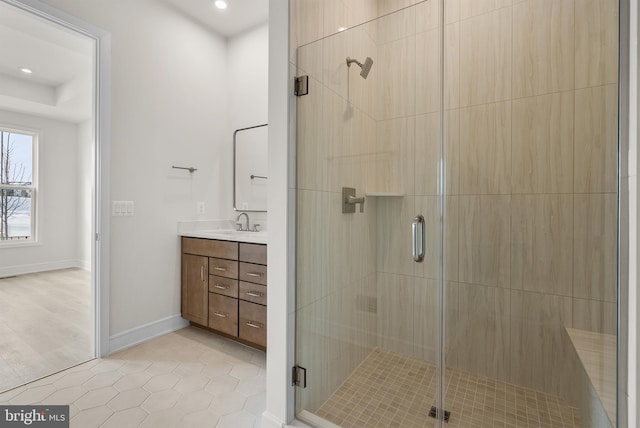 bathroom featuring tile patterned flooring, vanity, and a shower with shower door