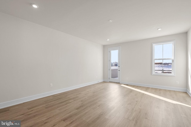 unfurnished room with light wood-type flooring