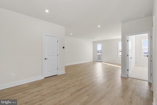 unfurnished room with light wood-type flooring