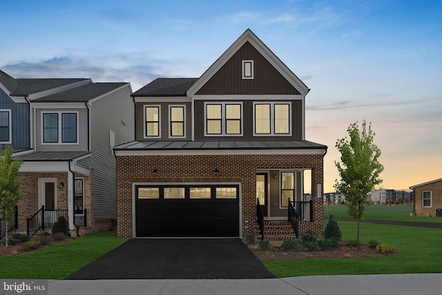 view of front facade featuring a garage and a lawn