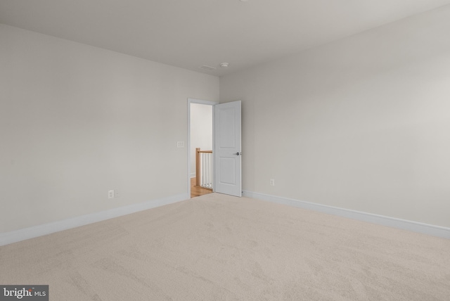 empty room featuring light colored carpet