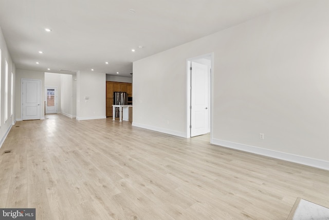 unfurnished living room with light wood-type flooring