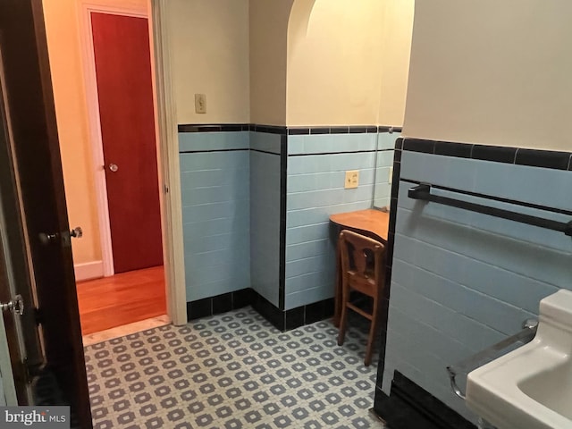 bathroom with tile walls