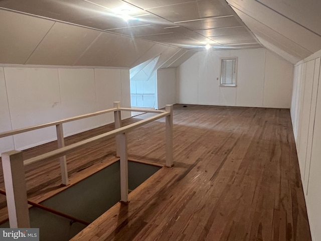 additional living space featuring vaulted ceiling and hardwood / wood-style floors