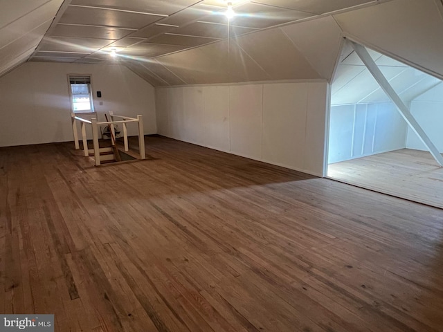 additional living space featuring lofted ceiling and hardwood / wood-style floors