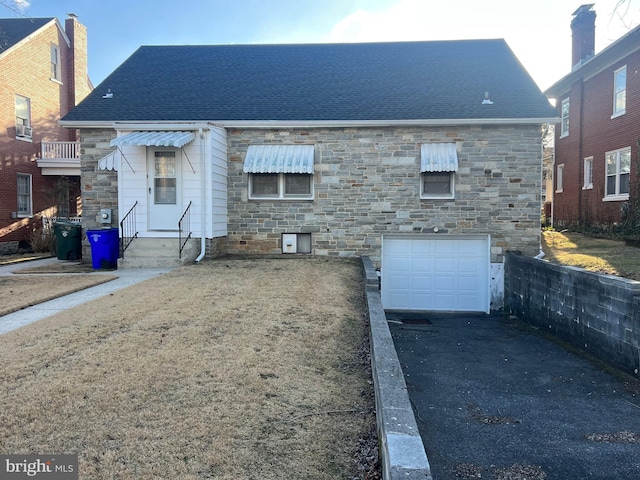 rear view of house with a garage