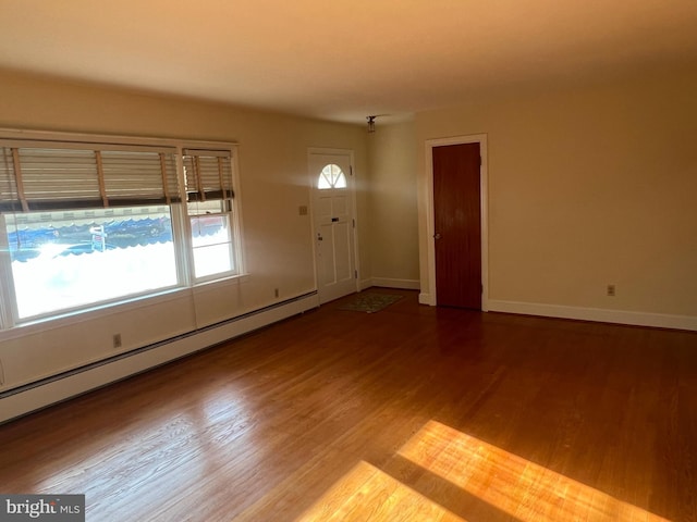 interior space featuring baseboard heating and hardwood / wood-style floors