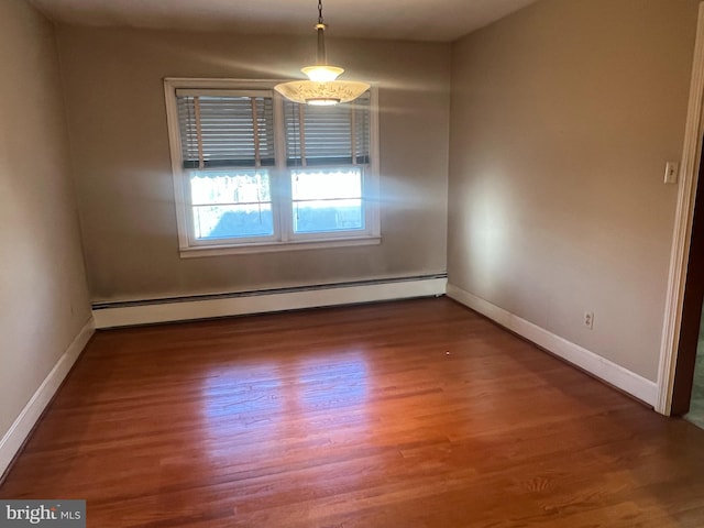 empty room with a baseboard radiator and dark hardwood / wood-style flooring