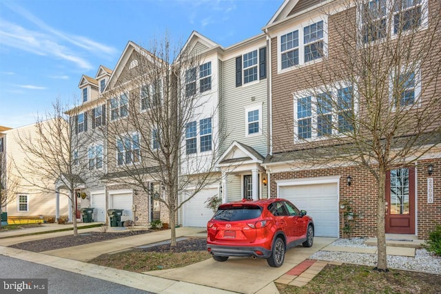 townhome / multi-family property featuring driveway, an attached garage, and brick siding