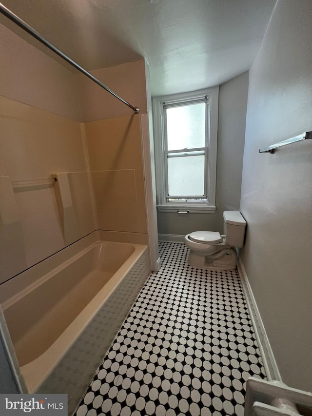 bathroom featuring toilet and bathing tub / shower combination