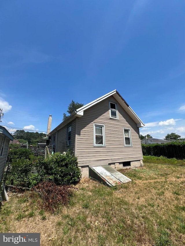 view of side of property with a yard