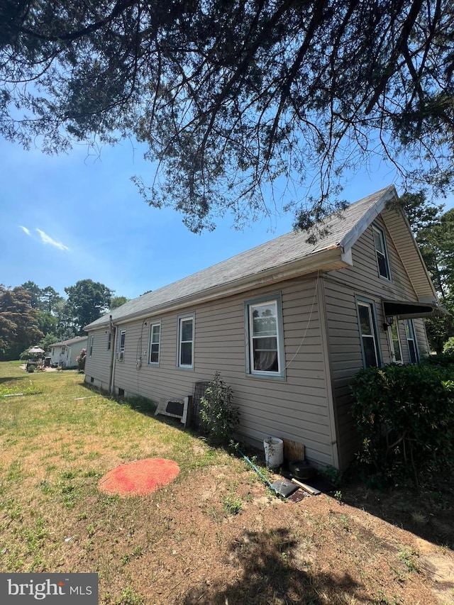 view of side of property with a yard