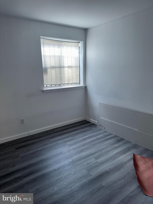 empty room with dark hardwood / wood-style floors