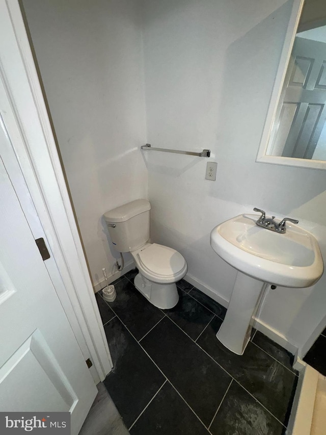 bathroom with sink, tile patterned floors, and toilet