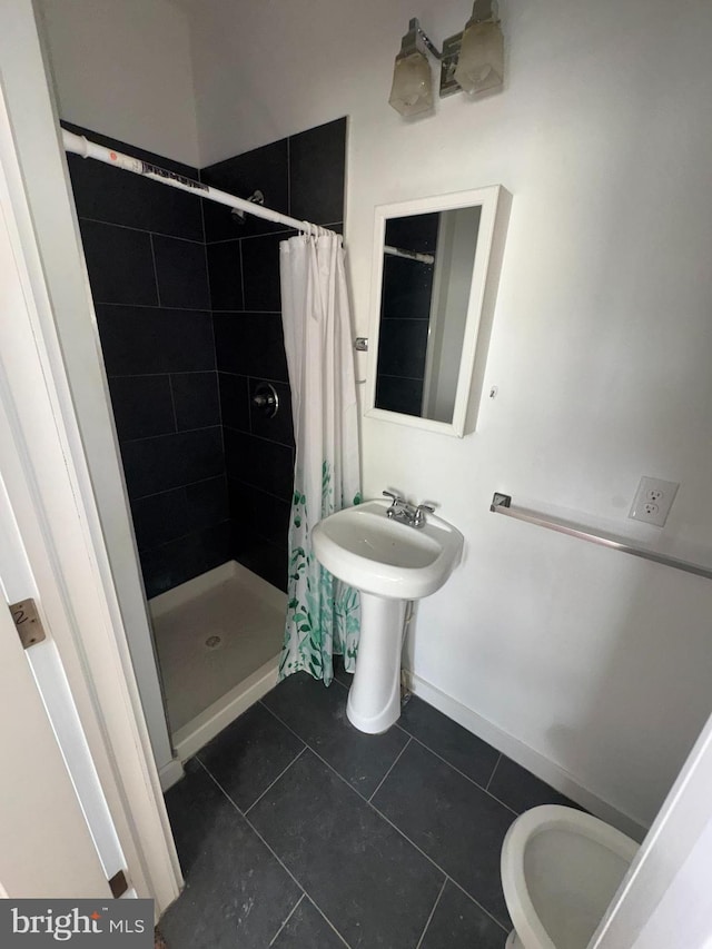 bathroom with toilet, tile patterned floors, and a shower with curtain