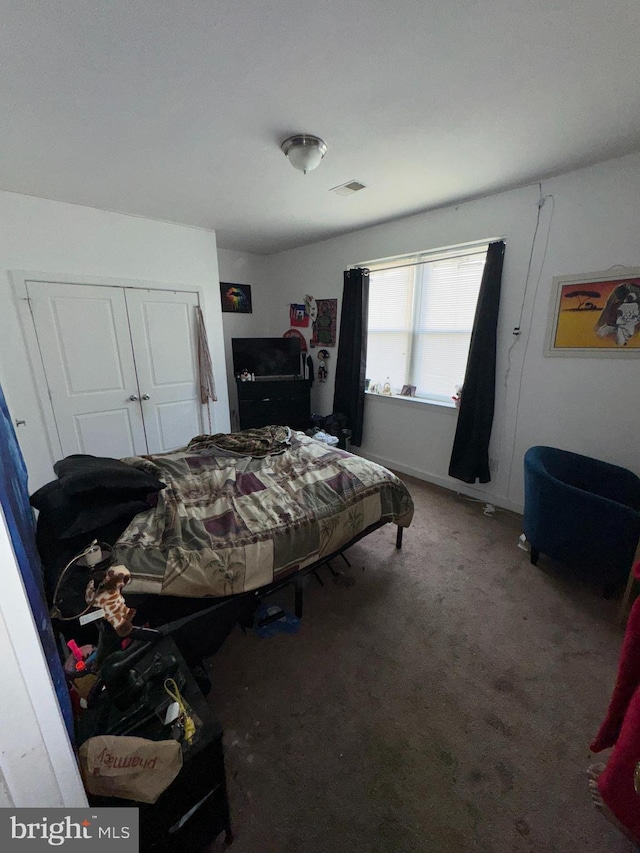 carpeted bedroom with a closet