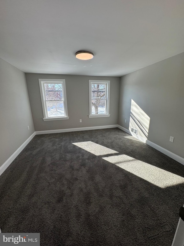 carpeted empty room featuring a healthy amount of sunlight