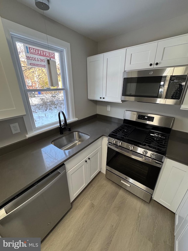 kitchen featuring white cabinetry, appliances with stainless steel finishes, and sink