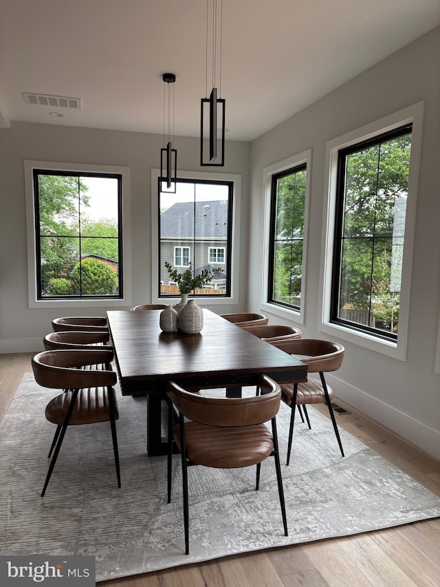 dining area with baseboards and light wood-style floors