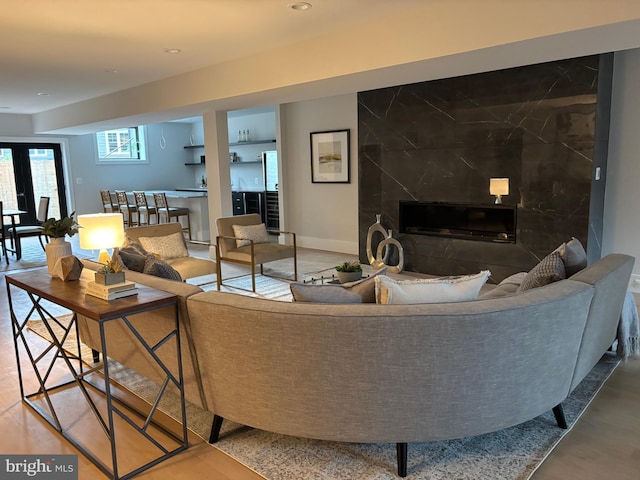 living room featuring a fireplace, baseboards, and recessed lighting