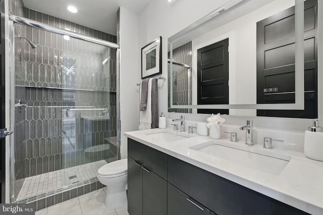 full bath with marble finish floors, a stall shower, toilet, double vanity, and recessed lighting