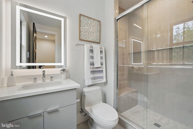 full bath with toilet, a shower stall, and vanity