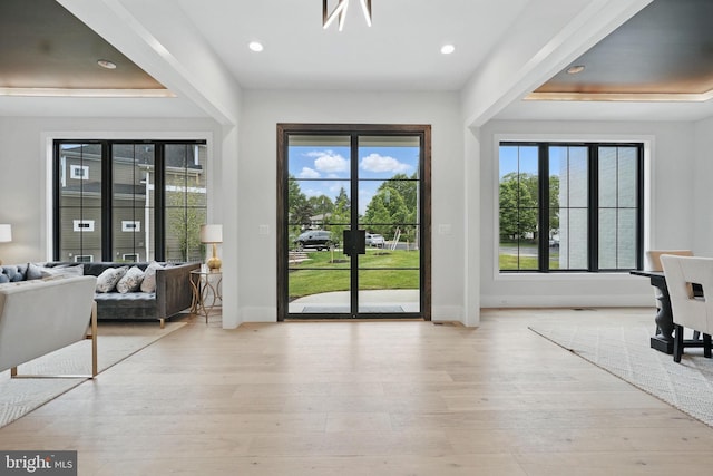 entryway with baseboards, light wood finished floors, and recessed lighting