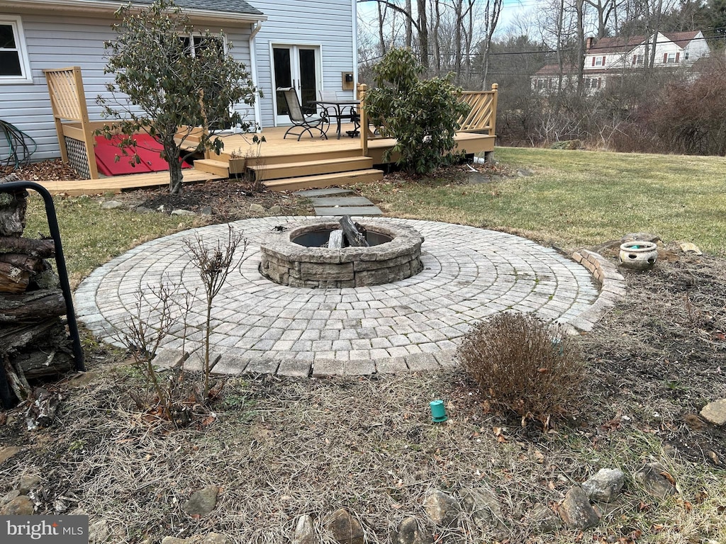 view of yard featuring a fire pit and a deck